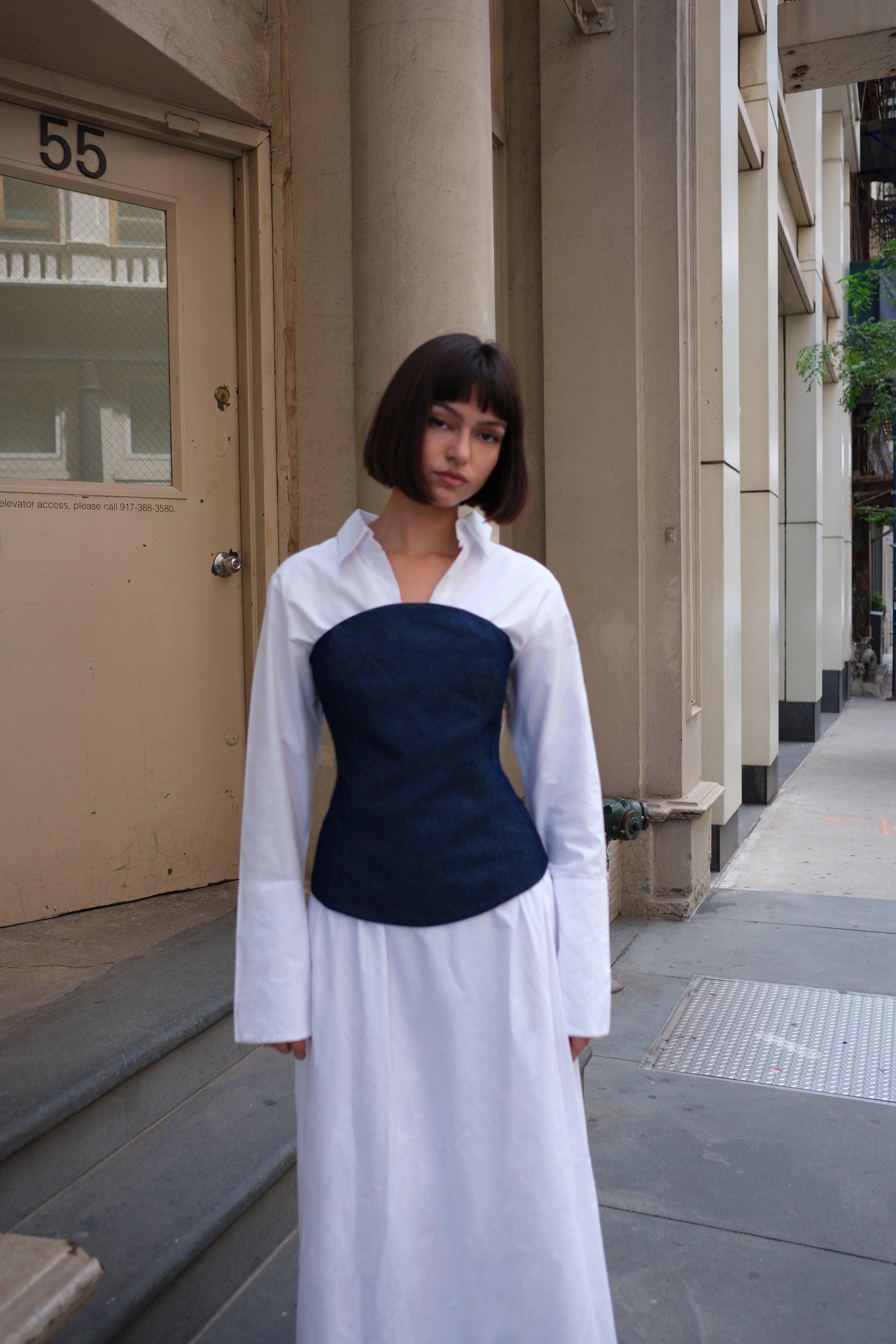 a white cotton maxi dress with a navy denim corset
